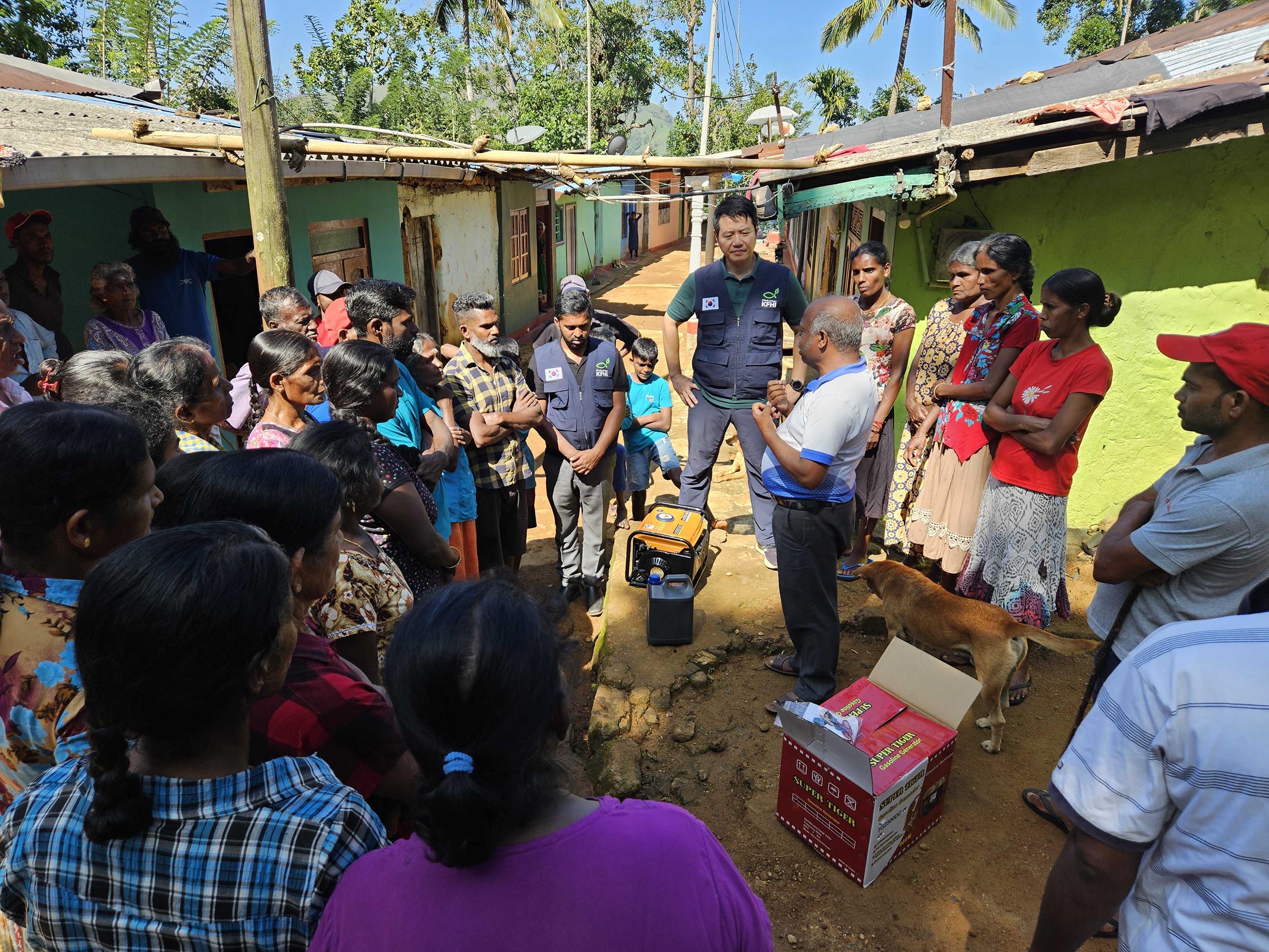  기아대책 구호팀이 스리랑카 피해 마을을 방문해 발전기 사용법 및 임산부·아동 안전 관리 등에 대해 설명하고 있다